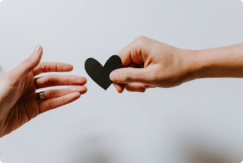 What is Mental Health Treatment: Two hands exchanging a paper heart