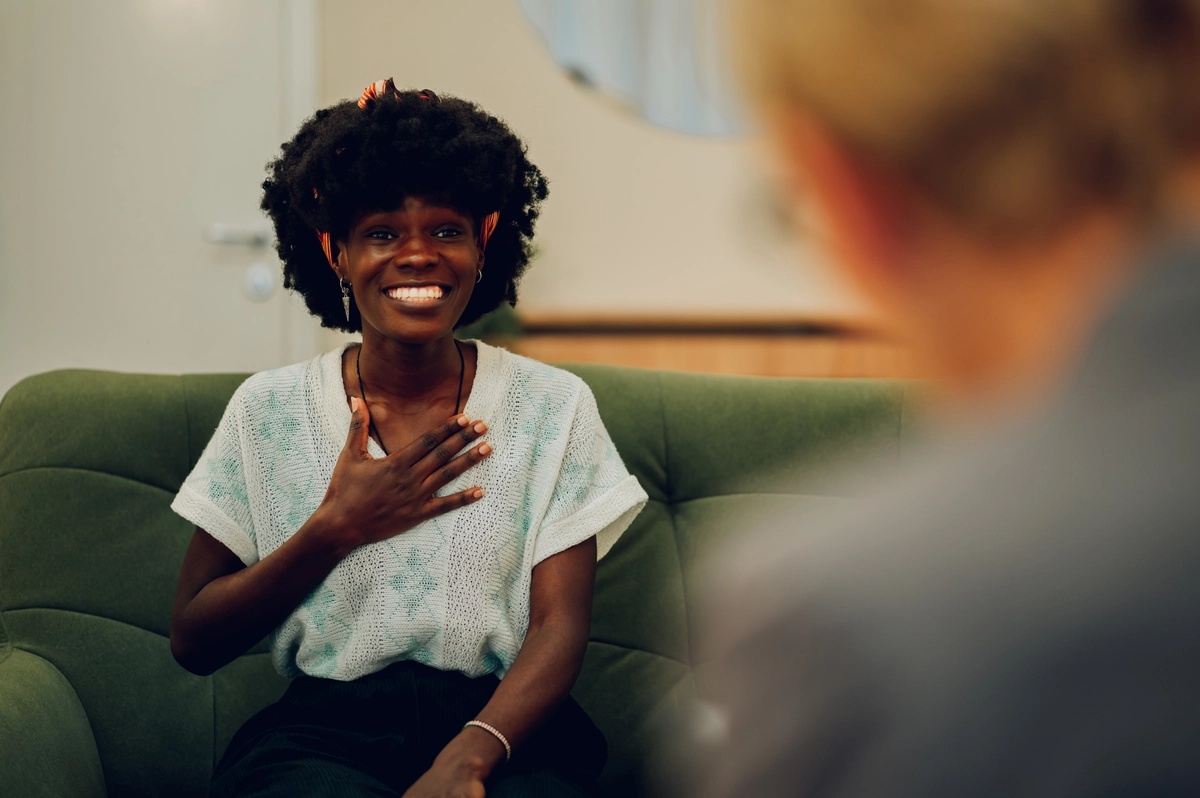 A woman in a therapy session, experiencing improvements after TMS treatment.