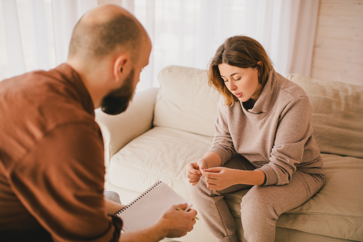 A woman in a therapy session, working through a dual diagnosis involving substance use and mental health.
