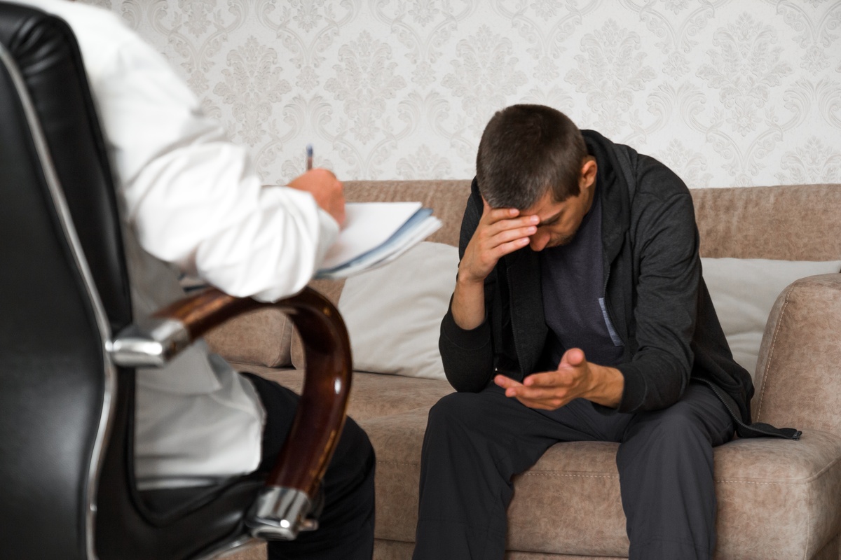 A man speaking with his therapist about his stimulant addiction, a critical part of treatment for substance use.