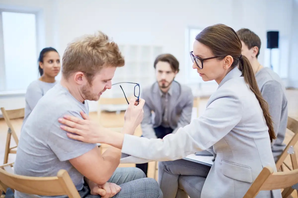 A man sitting in on a group therapy to support his adjustment disorder.