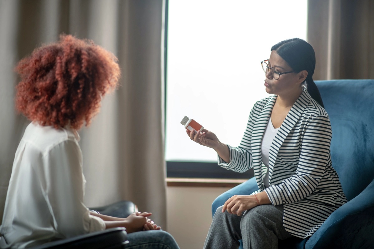 A therapist discussing the possibility of medication-assisted treatment with a patient.