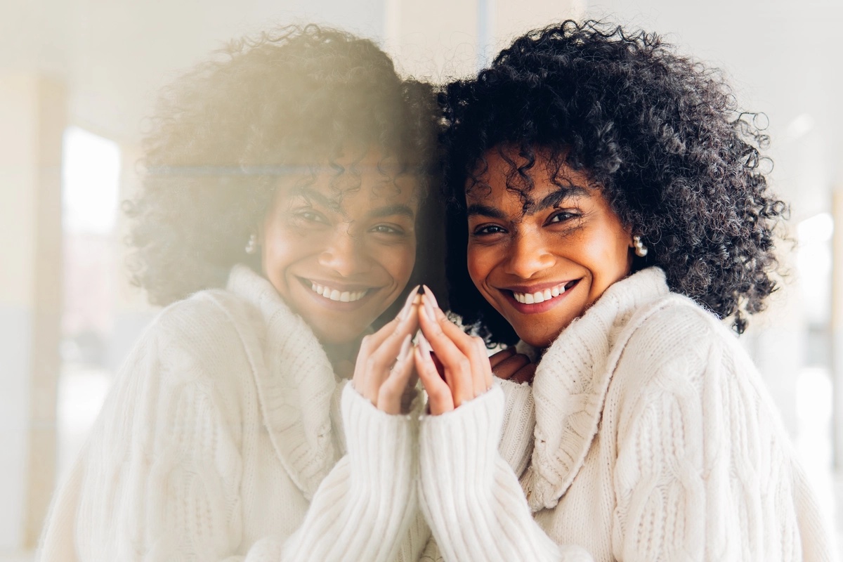 A woman smiling after experiencing the benefits of inpatient rehab and achieving long-term sobriety.