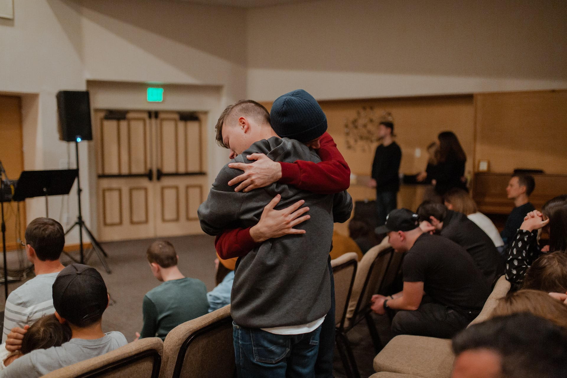 Picture of two people hugging at a support group meeting.