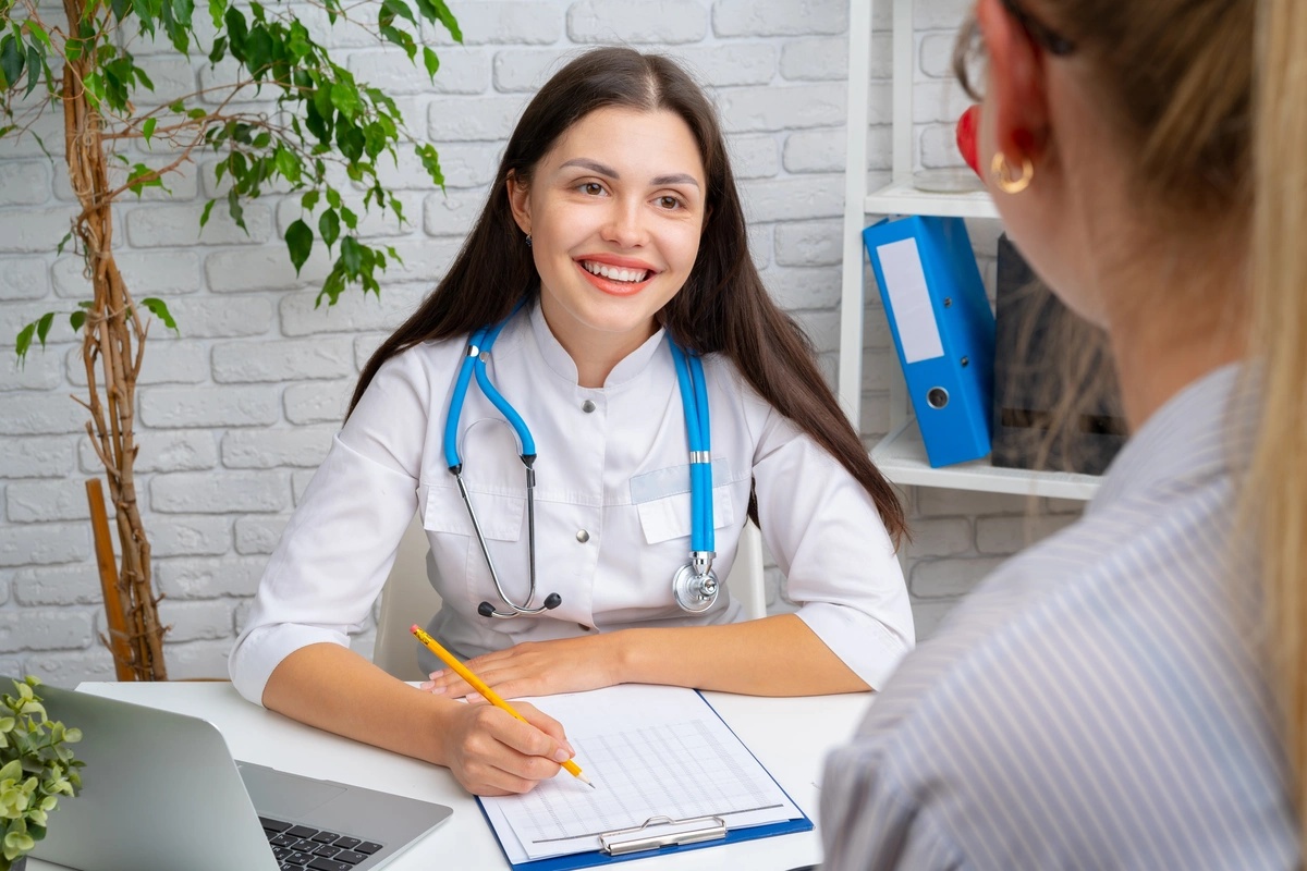 A doctor smiling and talking to a patient about the benefits of inpatient rehab.