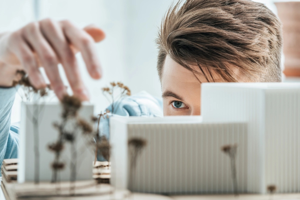 A man arranging things on his desk.