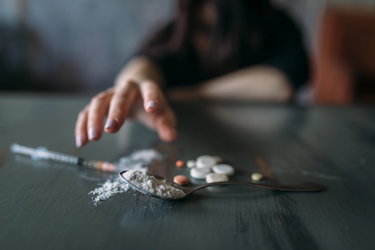 A person reaching for another dose of fentanyl, representative of fentanyl addiction.