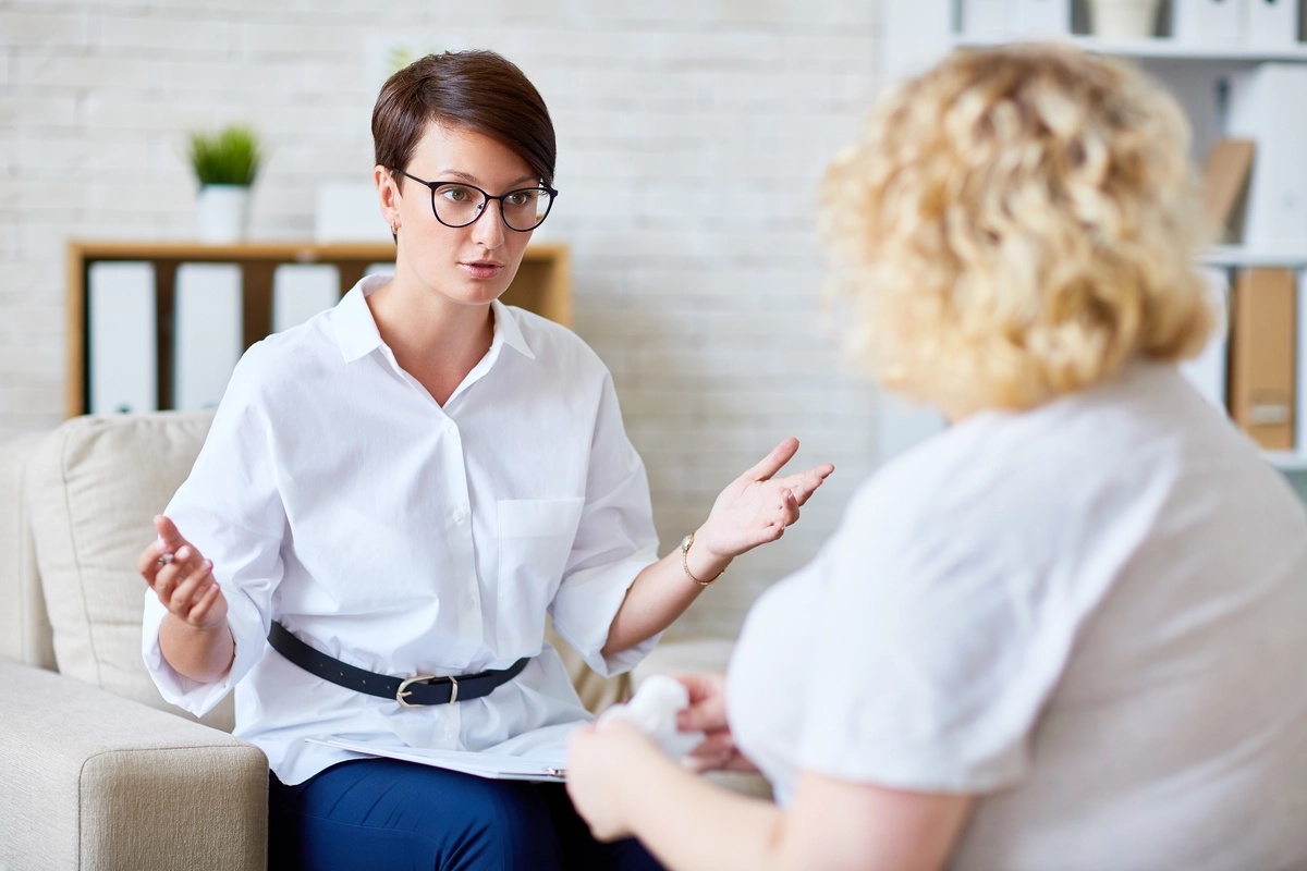 Two women participate in a counseling session about undifferentiated schizophrenia.