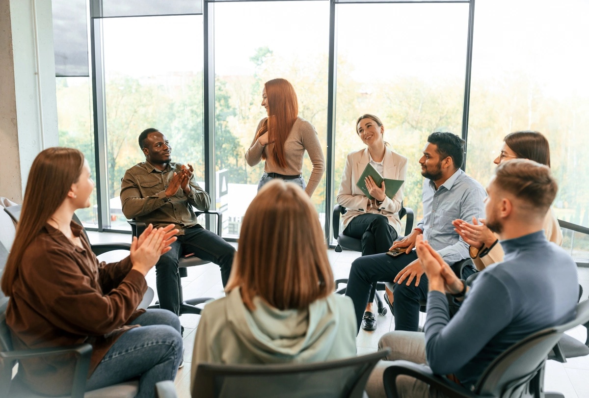 A woman sharing her story in a group therapy setting.