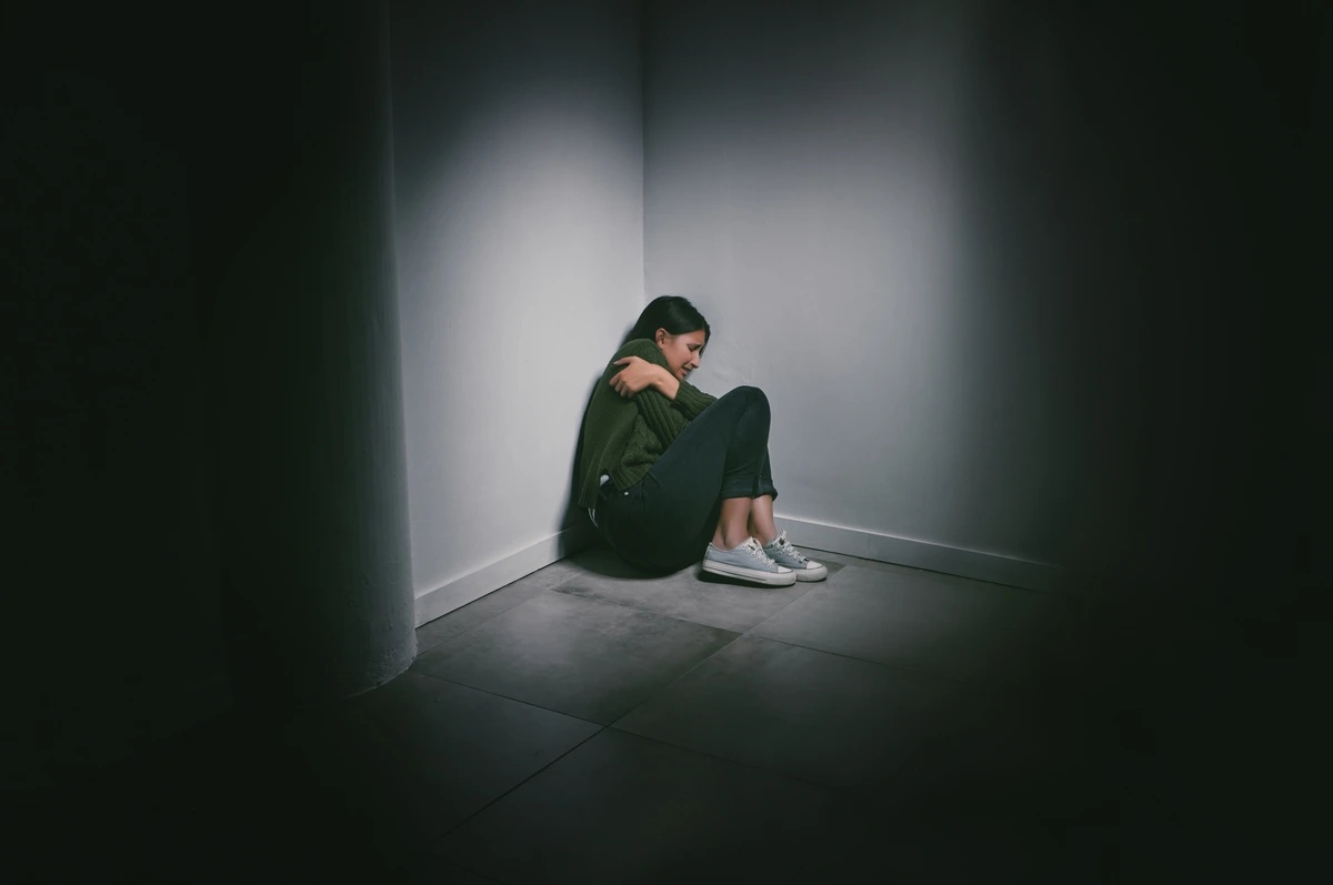 A young woman is wedged into the corner