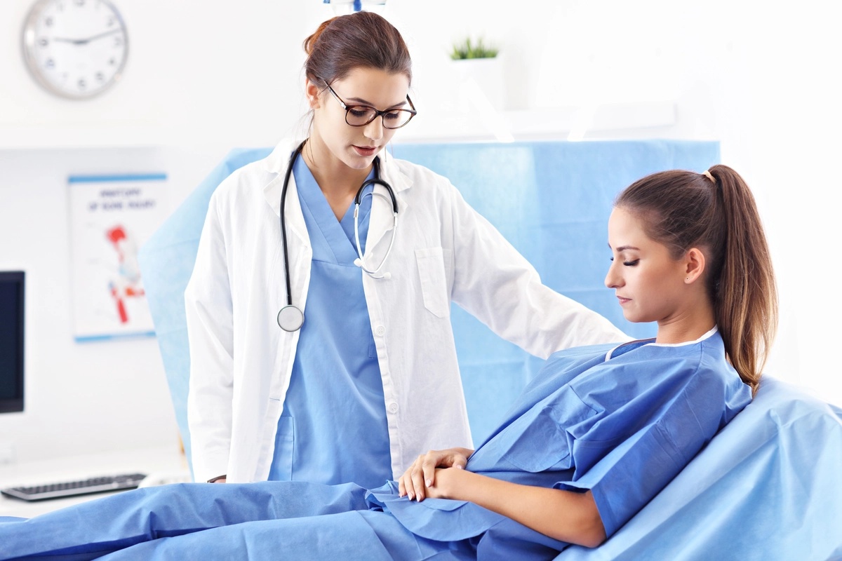 A woman in inpatient rehab speaking with a healthcare professional.