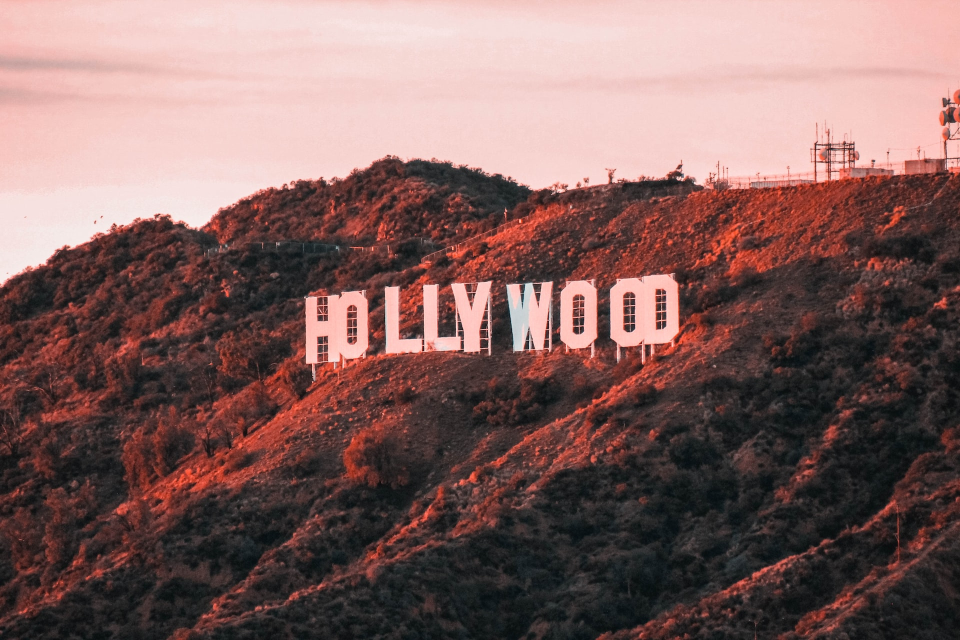 Photo of the iconic "Hollywood" sign at sunset.