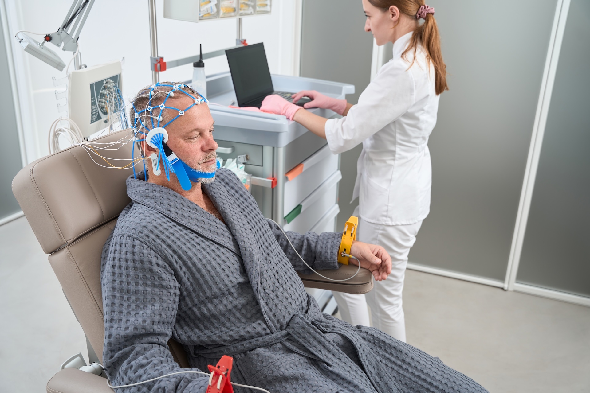 man-sits-in-medical-chair-with-electrodes-on-his-h-2024-10-18-17-27-11-utc