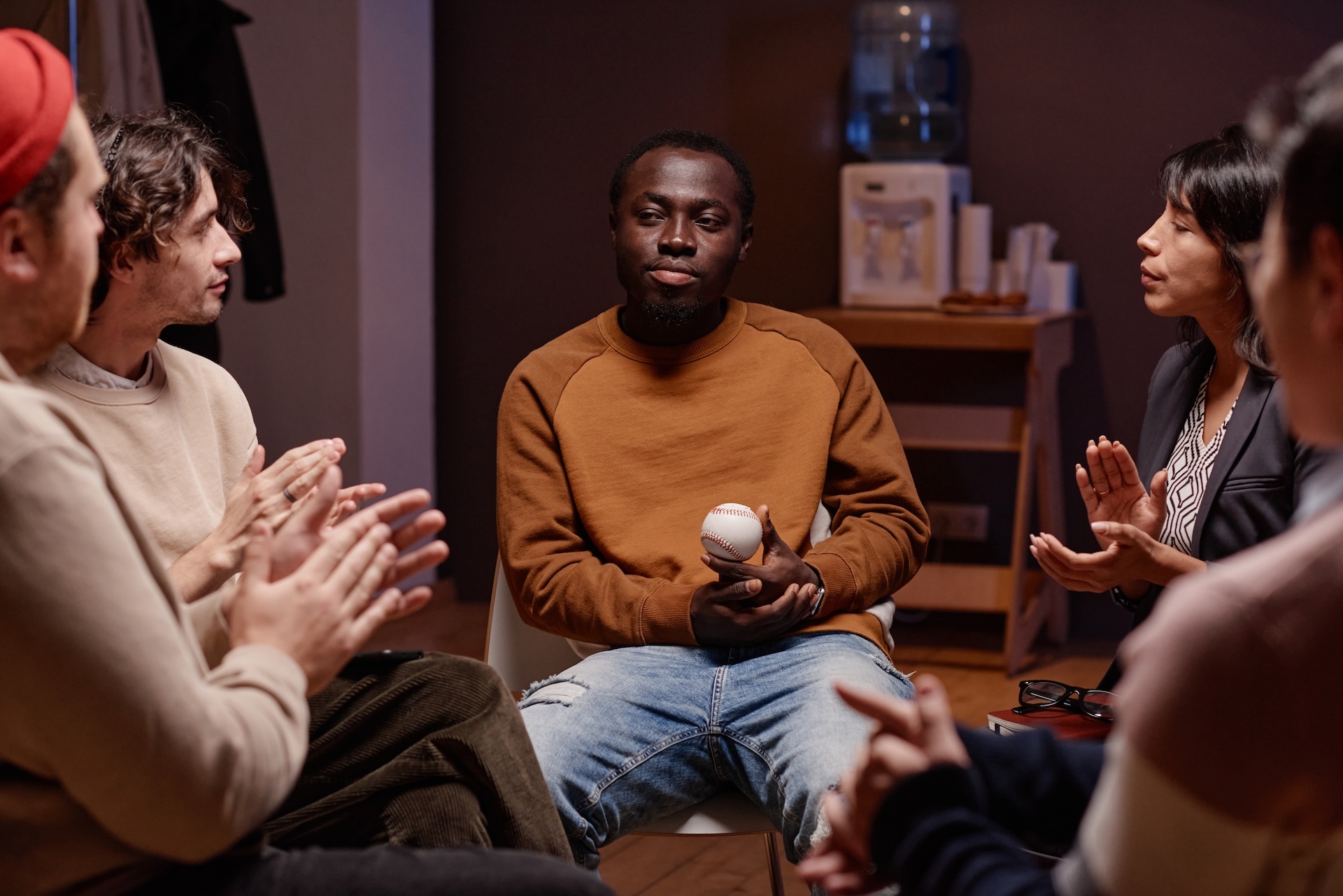 clapping-to-man-during-group-therapy-2025-03-18-22-10-20-utc (1)