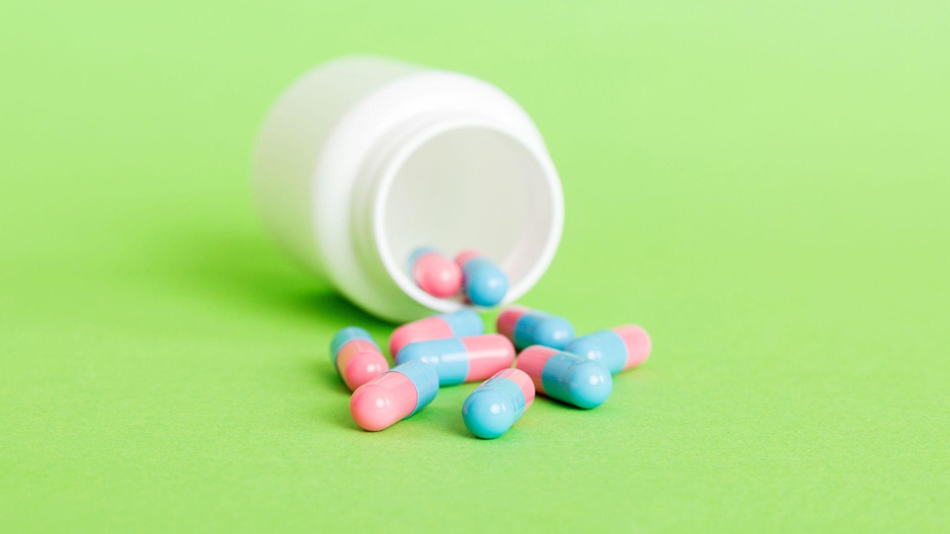 Phentermine Addiction pills dropped on a green surface