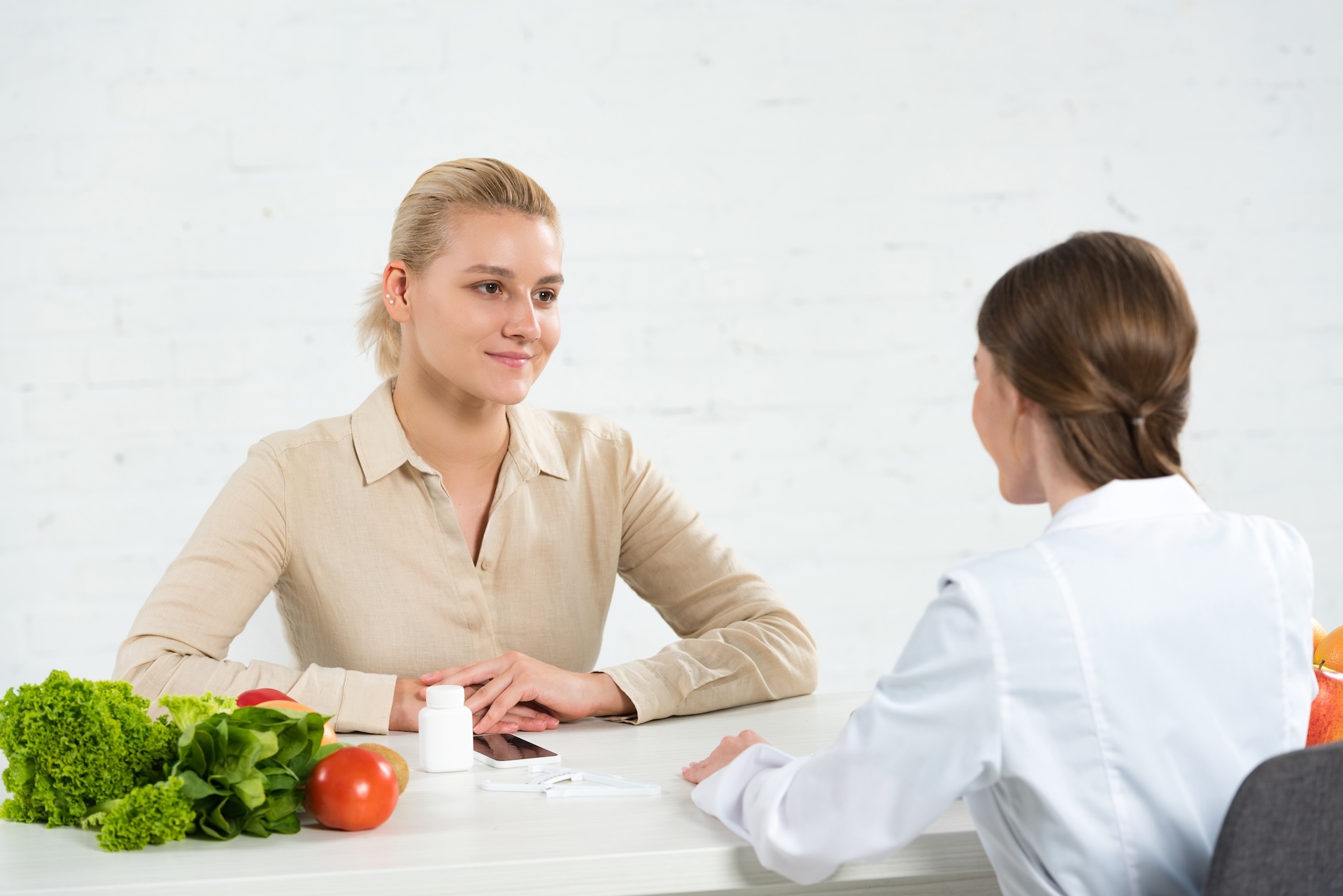 dietitian-in-white-coat-and-patient-looking-at-eac-2024-11-08-22-05-06-utc