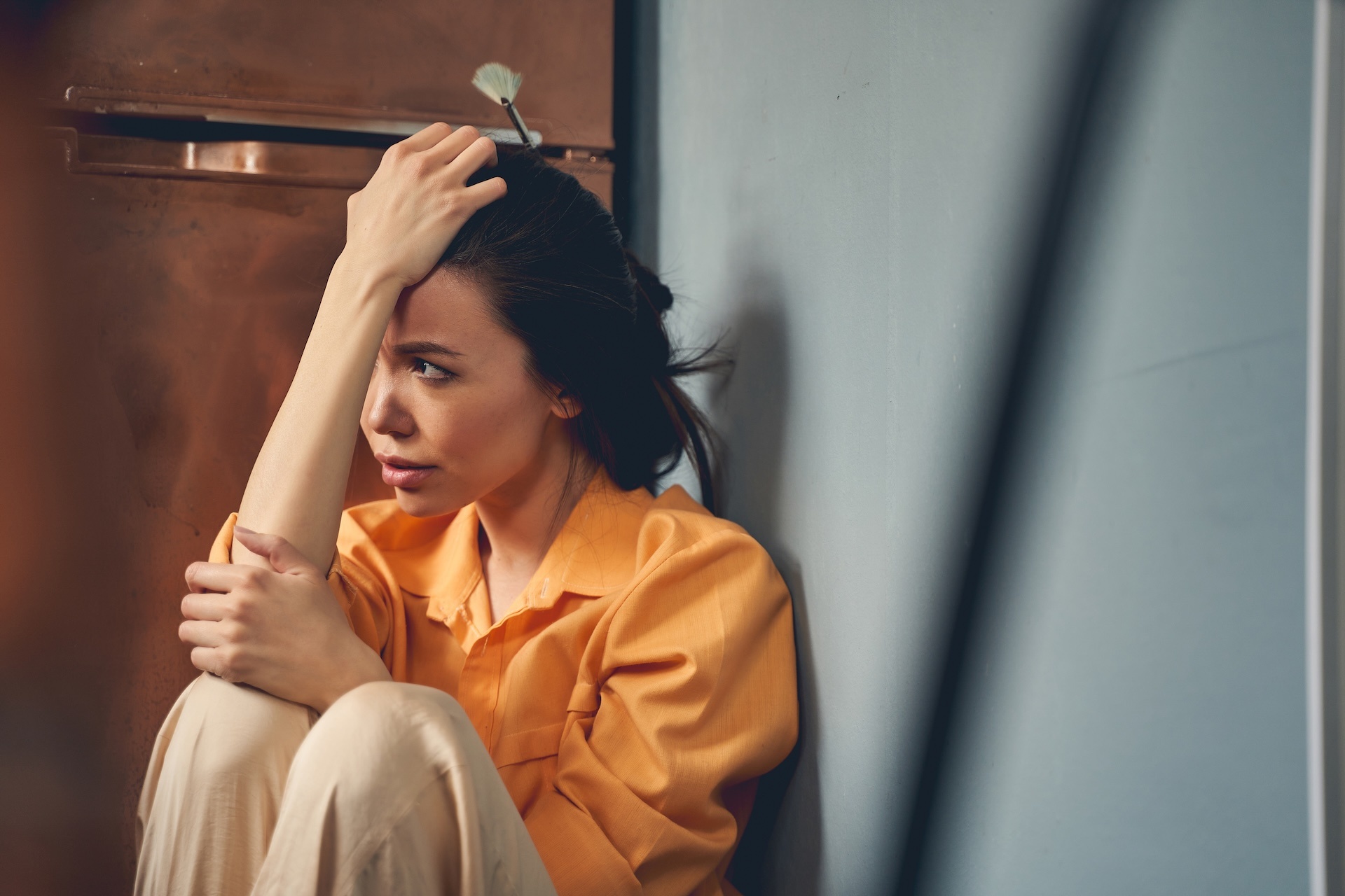 upset-young-lady-sitting-on-the-floor-at-home-2025-03-10-07-18-18-utc