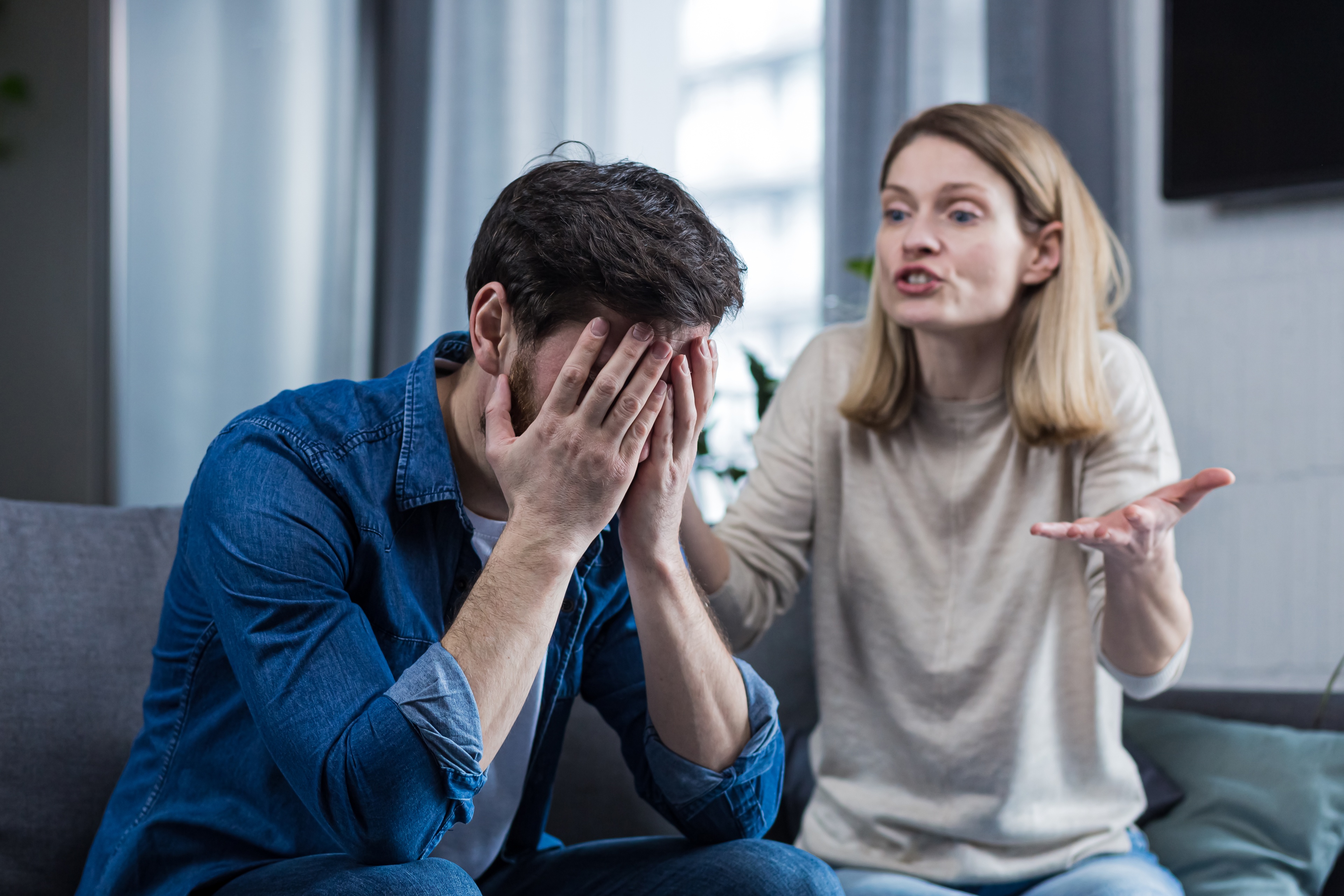 Sex addiction causing marital issues between a middle-aged couple, with the husband holding his hands to his face. Sex addiction causing marital issues between a middle-aged couple, with the husband holding his hands to his face.
