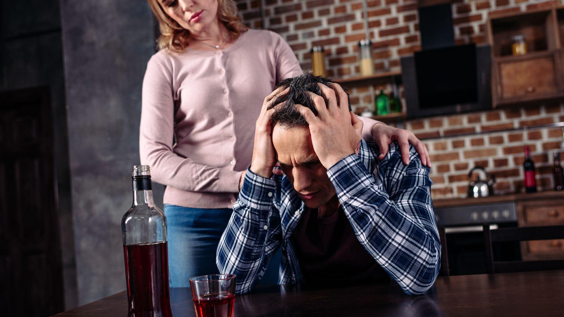 Alcoholic conditions: man at bar upset about condition caused by alcohol addiction.
