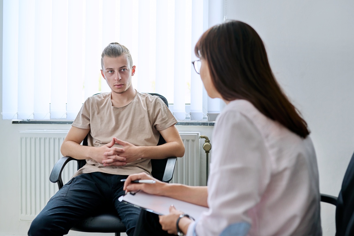 A man speaking to his healthcare provider about MAT options to treat his opioid addiction.