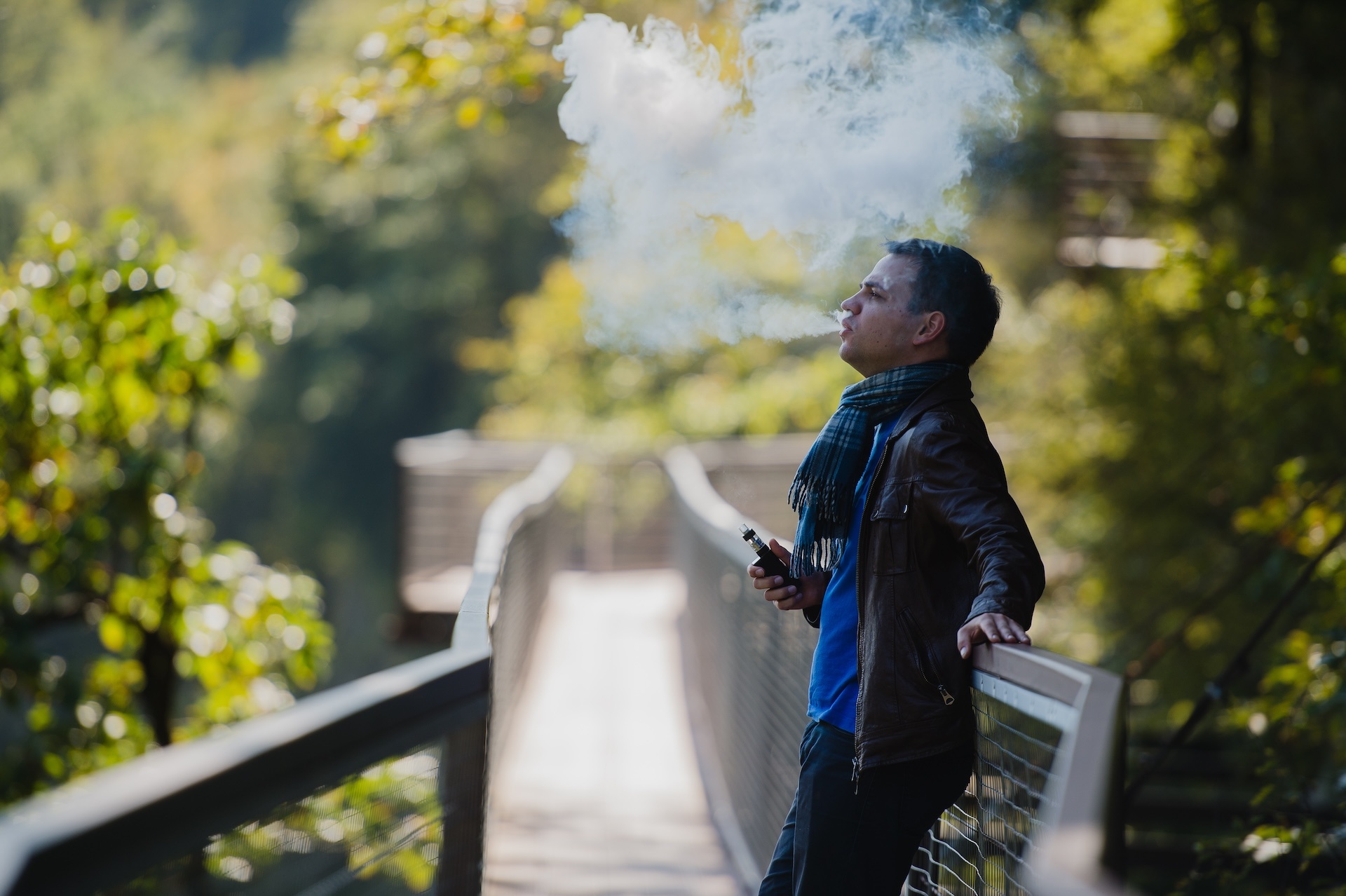 young-man-with-custom-box-mode-vape-device-vaping-2024-11-03-00-45-52-utc