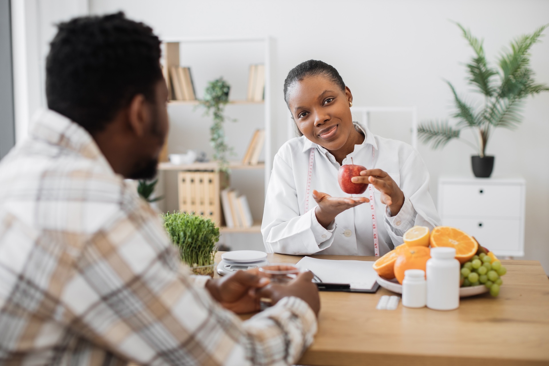 nutritionist-holding-apple-with-measuring-tape-at-2024-12-12-23-53-10-utc
