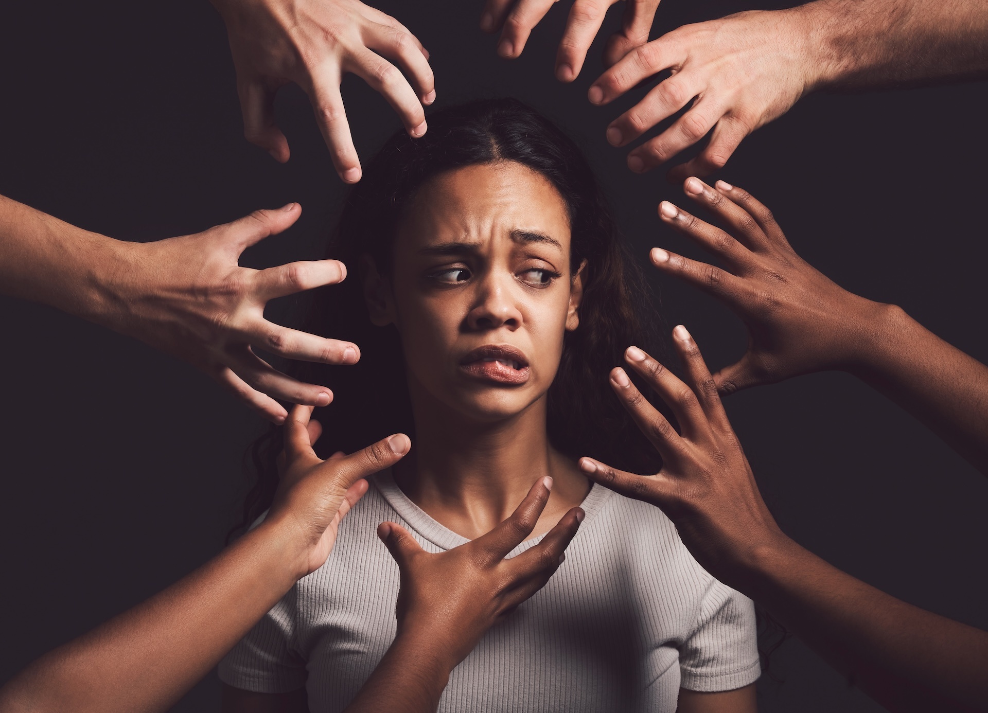 shot-of-hands-grabbing-a-young-womans-against-a-da-2023-11-27-04-56-12-utc