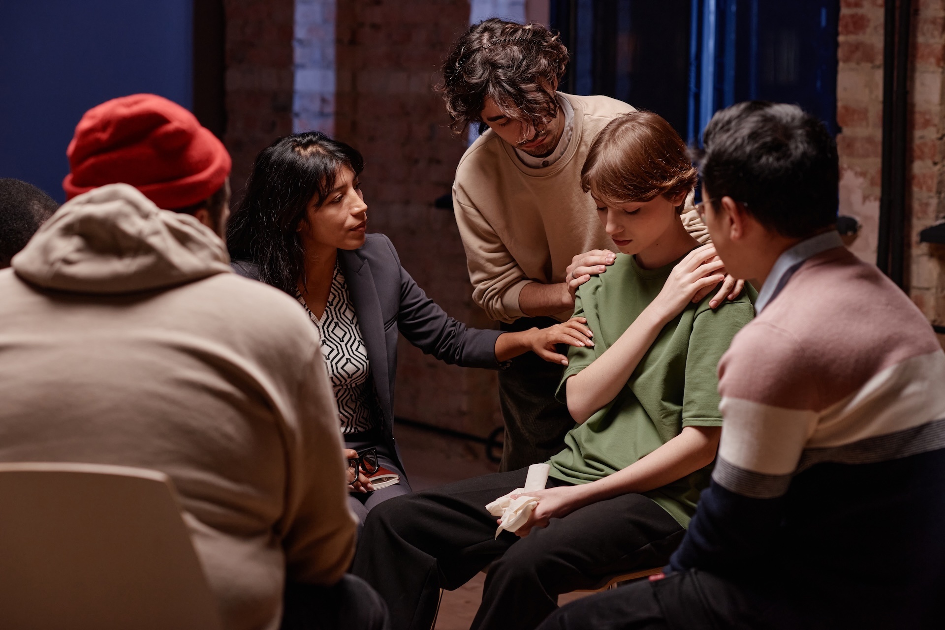 comforting-woman-during-group-therapy-2025-03-18-22-19-46-utc