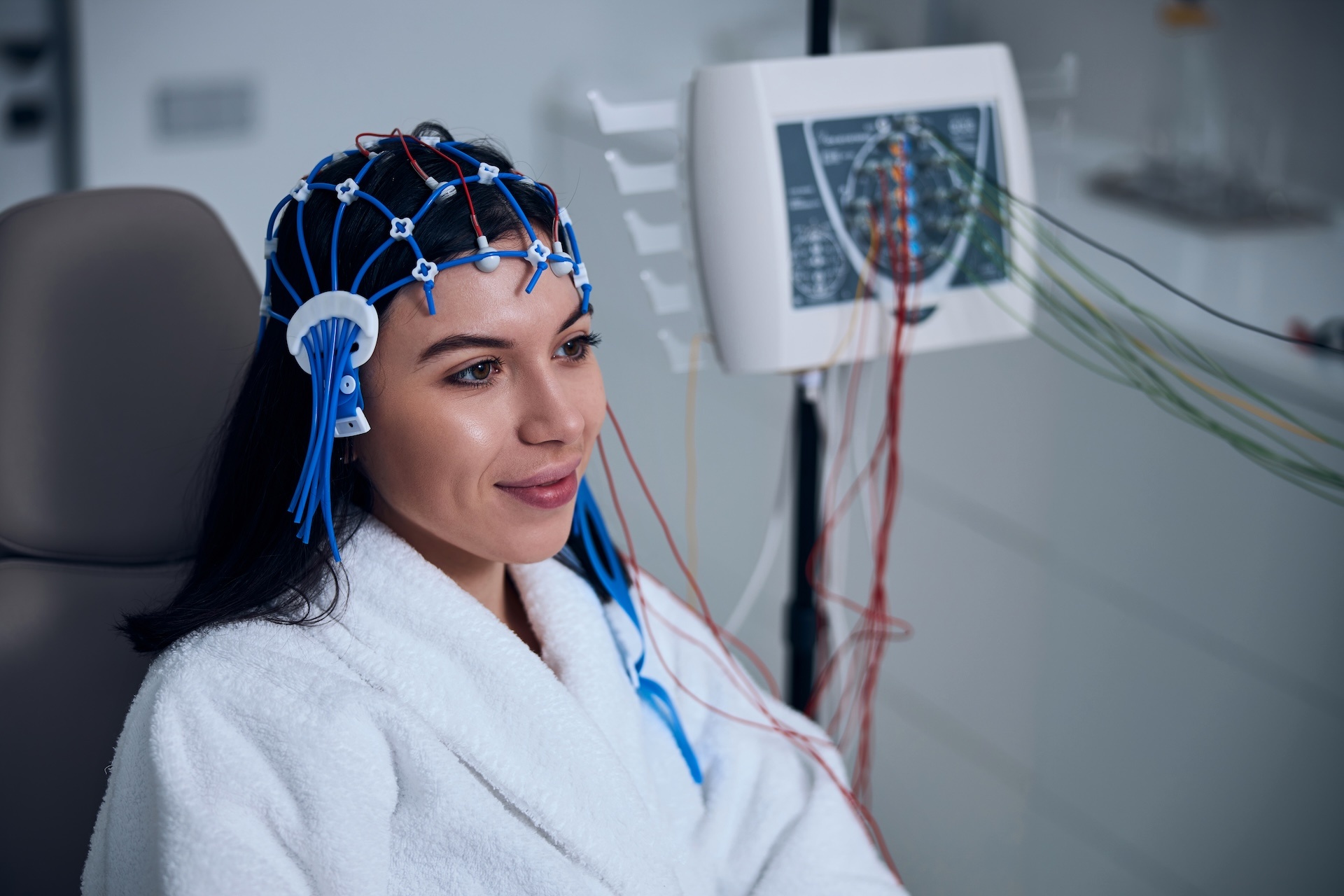 pleased-female-patient-undergoing-an-eeg-test-2023-11-27-05-25-09-utc