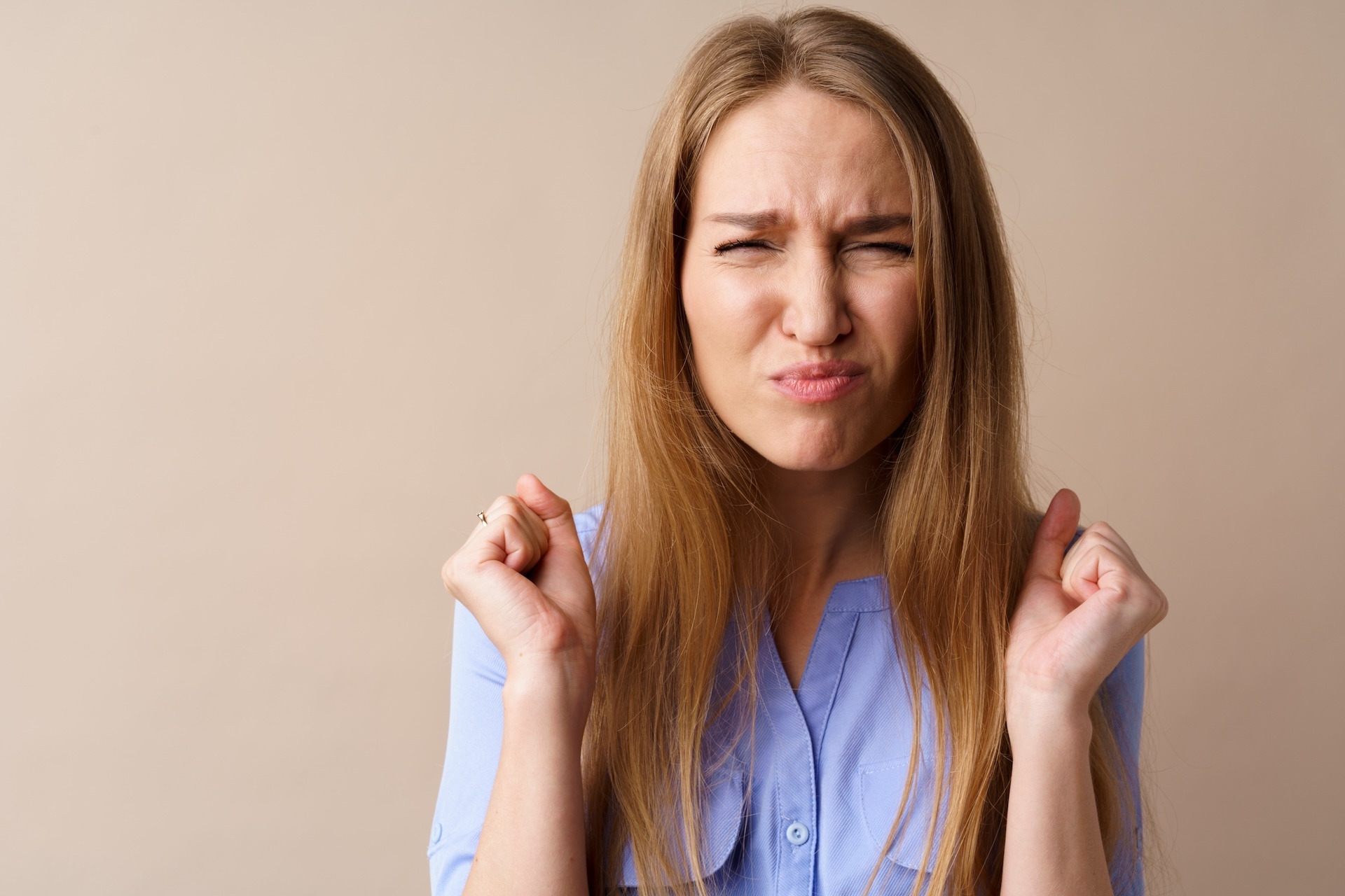 angry-stressed-mad-young-woman-against-beige-backg-2023-11-27-05-20-39-utc