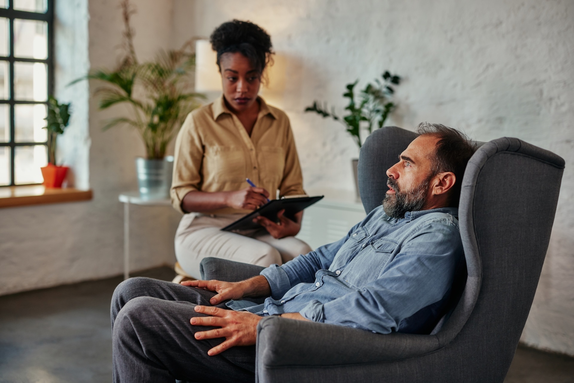 african-female-therapist-listens-to-mid-adult-male-2024-10-18-06-30-42-utc