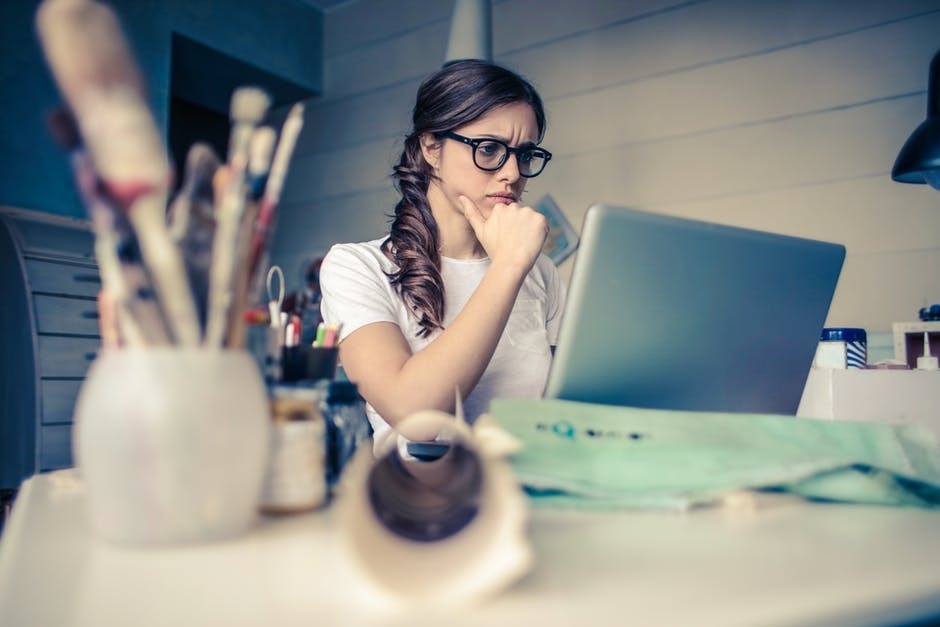 6 Steps for Choosing an Addiction Center A young woman staring intently at her laptop.