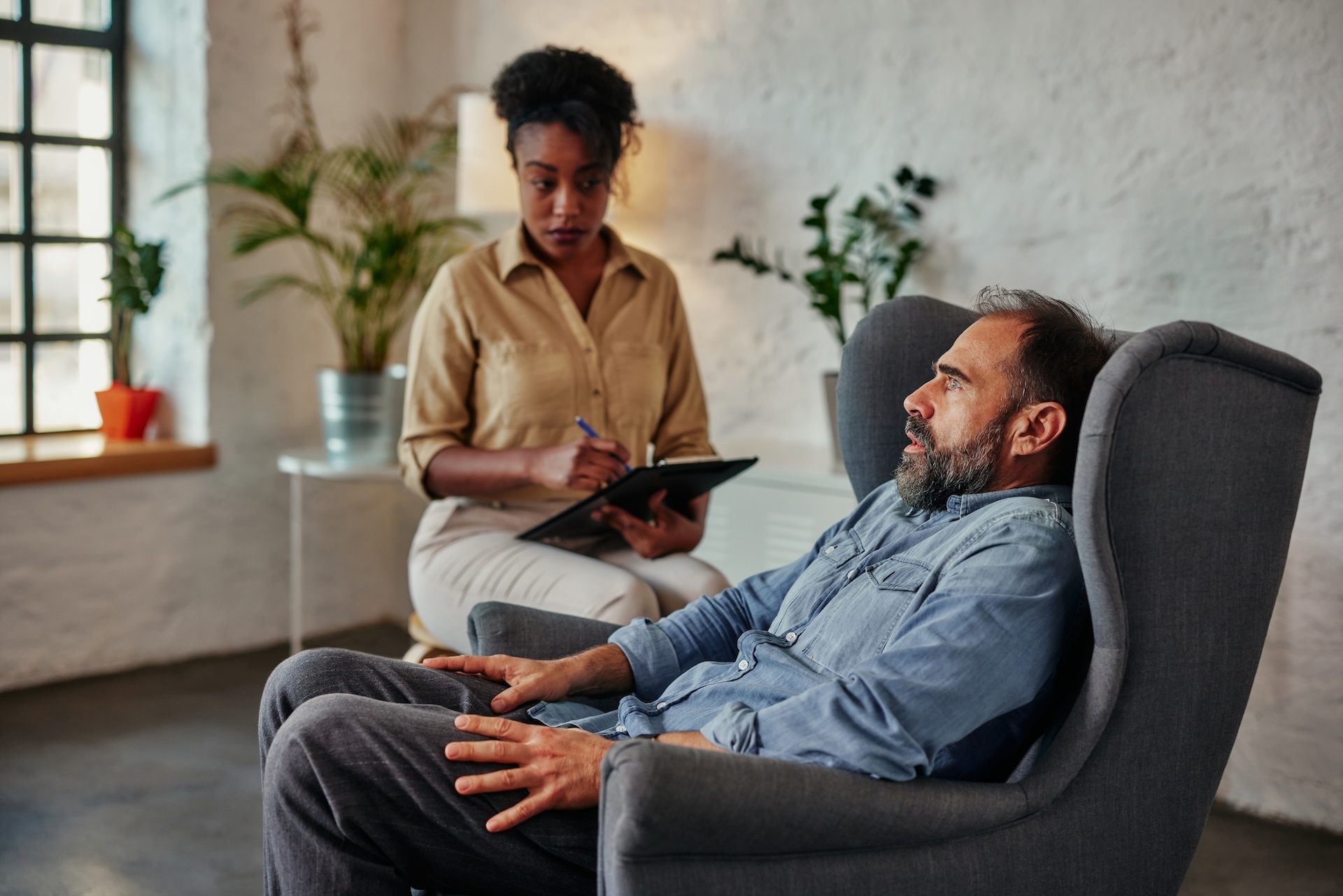 african-female-therapist-listens-to-mid-adult-male-2024-10-18-06-30-42-utc