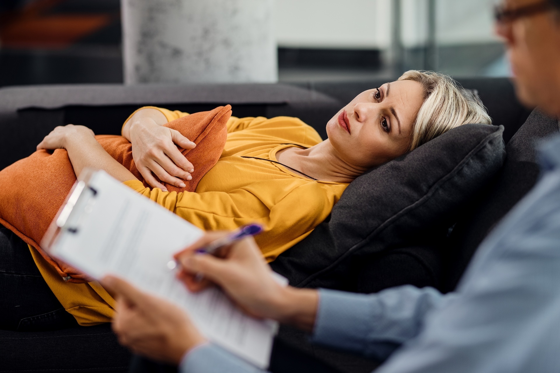 thoughtful-woman-lying-down-on-psychiatrist-s-couc-2024-12-13-18-30-13-utc