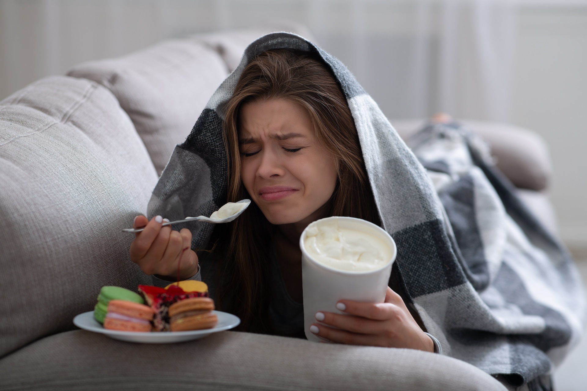 upset-young-woman-dealing-with-depression-by-eatin-2023-11-27-05-32-35-utc