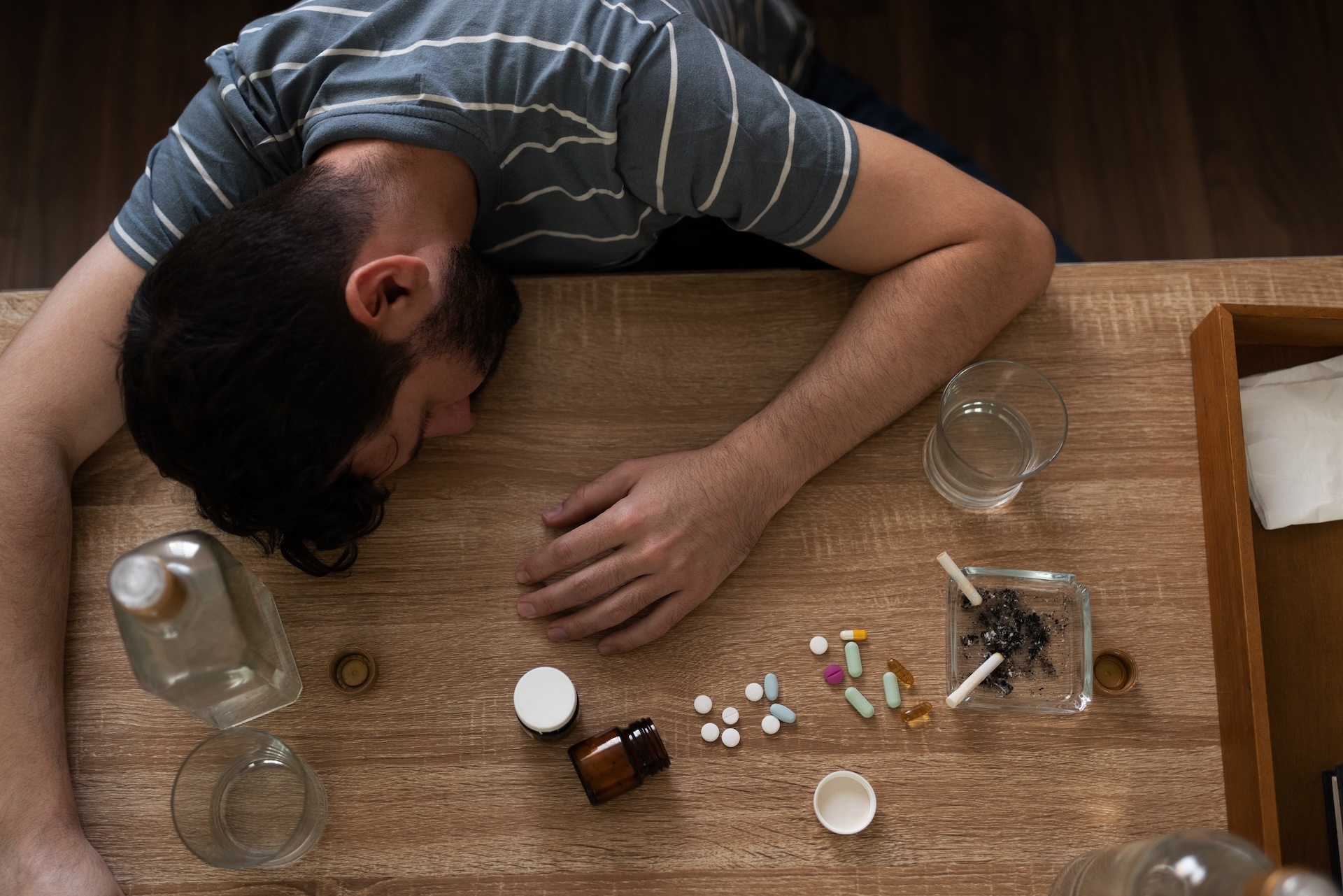 man-with-addictions-asleep-surrounded-by-drugs-2025-08-03-03-07-14-utc (1)