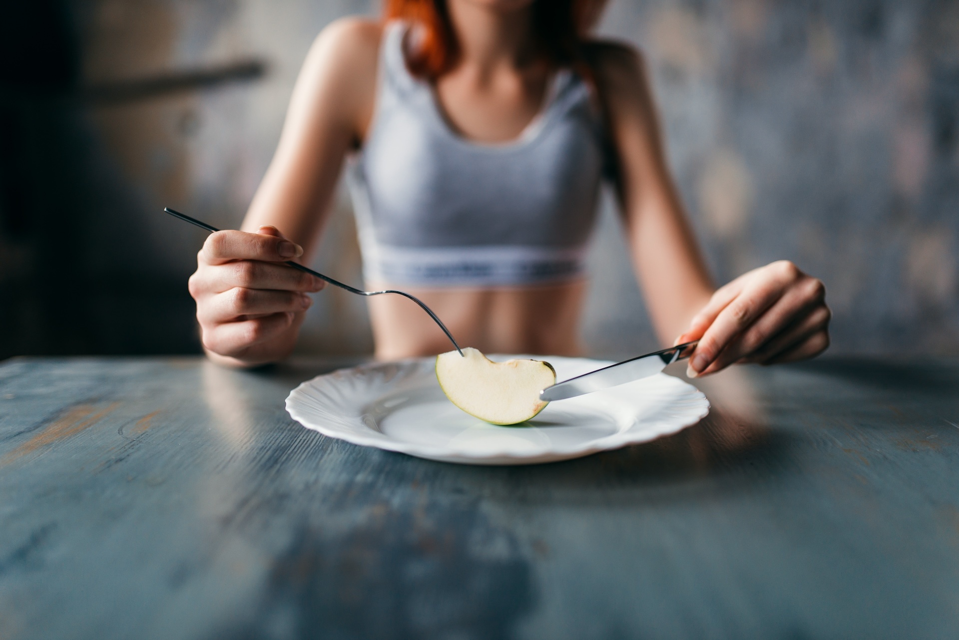 female-person-against-plate-with-a-slice-of-apple-2024-12-01-20-19-47-utc