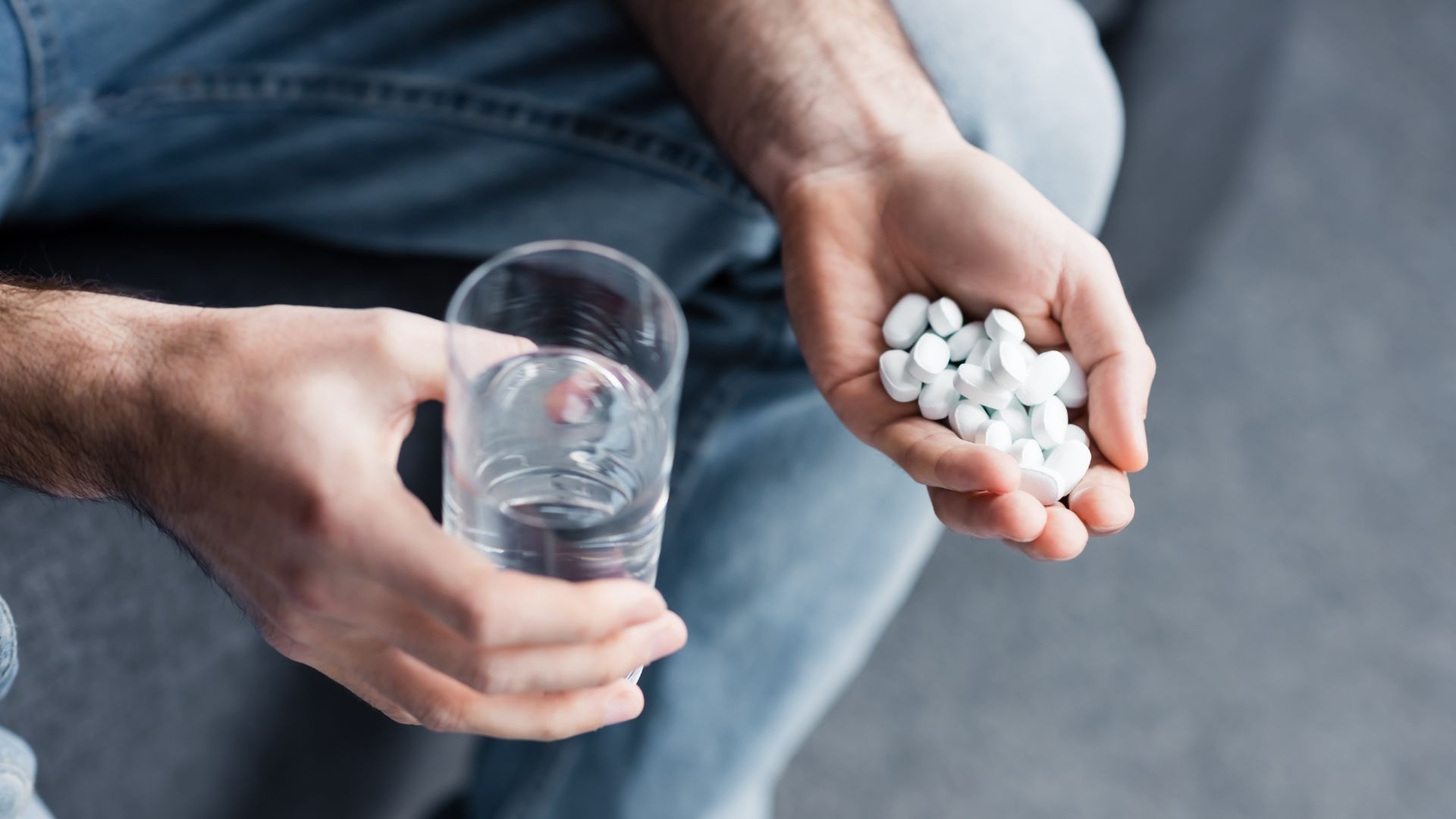 Oxycontin addiction: man holding multiple Oxycontin pills. Oxycontin addiction: man holding multiple Oxycontin pills.