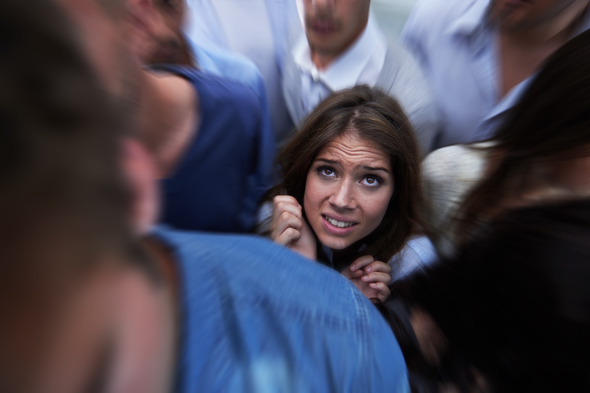drowning-in-people-shot-of-a-fearful-young-woman-2023-11-27-05-14-49-utc