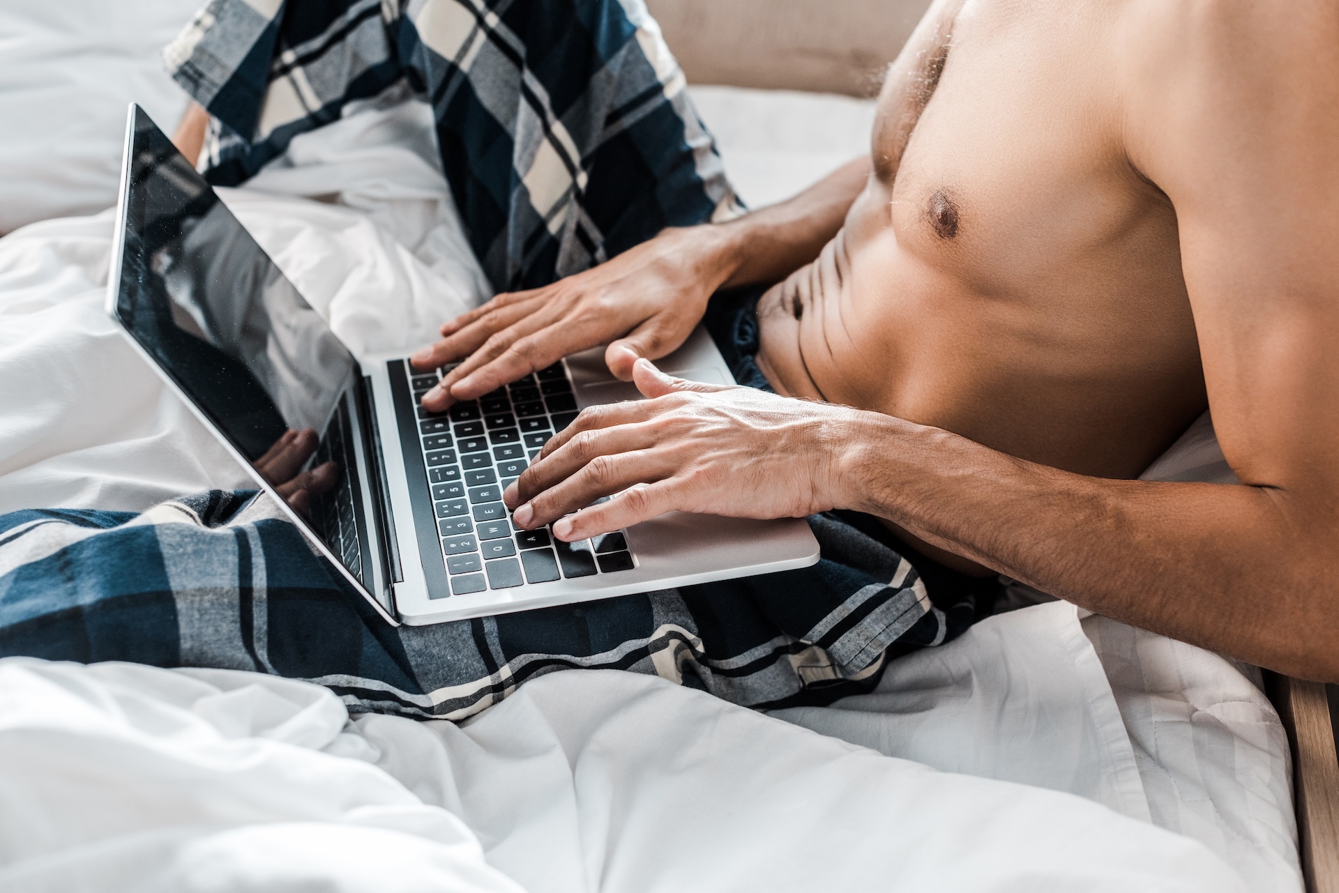 cropped-view-of-sexy-bi-racial-man-using-laptop-in-2024-11-11-21-56-39-utc