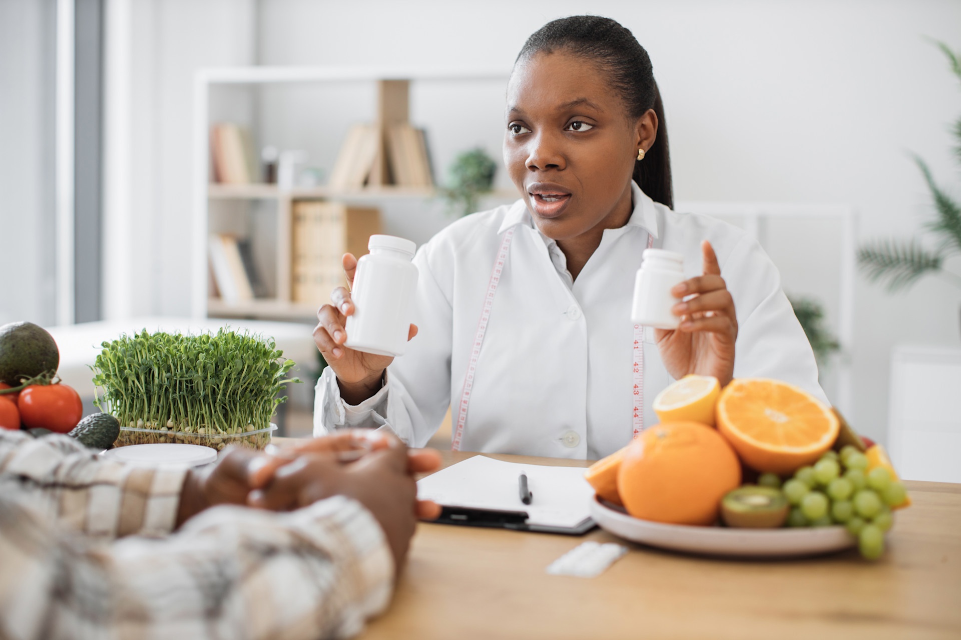 expert-in-diet-holding-bottles-with-pills-in-clini-2023-11-27-05-06-39-utc