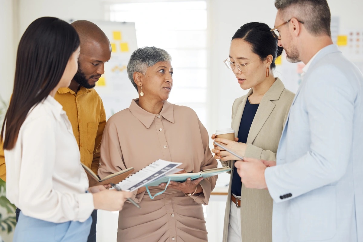 A group of therapists discussing techniques and strategies, such as the effectiveness of EMDR therapy.